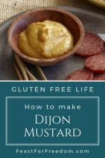 Pinterest mini image - Dijon mustard in a small wooden dish next to sliced sausage meat