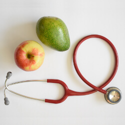 Stethoscope, apple and pear