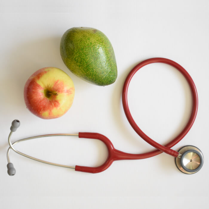 Stethoscope, apple and pear