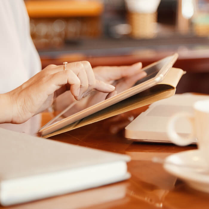 Woman typing on a tablet