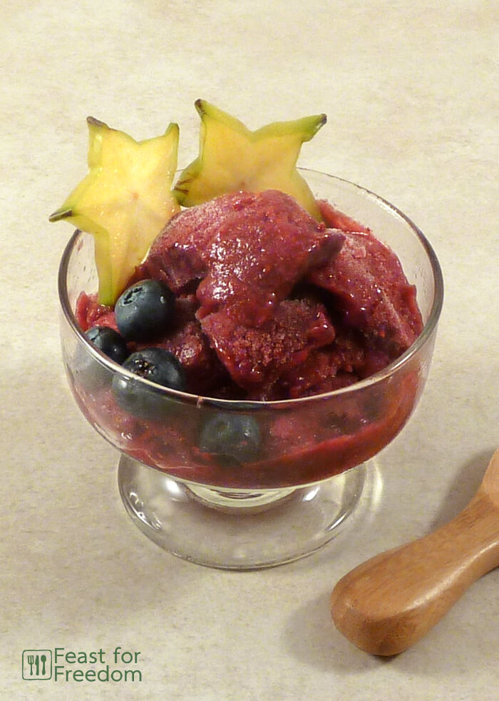Blackberry sorbet garnished with blueberries and starfruit