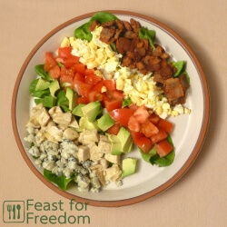 Fresh Cobb Salad on a plate, laid out in small rows