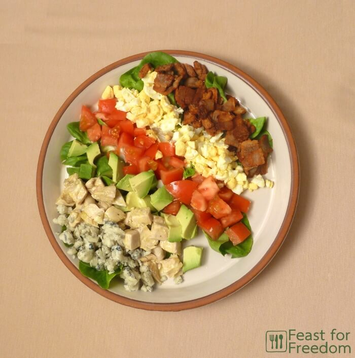 Fresh Cobb Salad on a plate, laid out in small rows