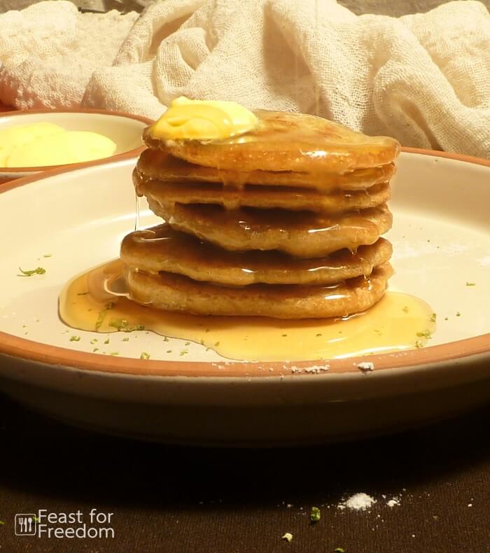 Stack of grain free and gluten free pancakes with butter and pancake syrup
