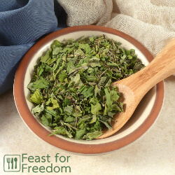 Italian seasoning in a small bowl with a spoon