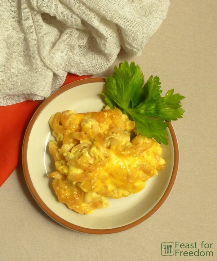Baked macaroni and cheese on a plate garnished with parsley