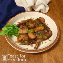 Maple glazed pork chops on a plate garnished with a celery sprig