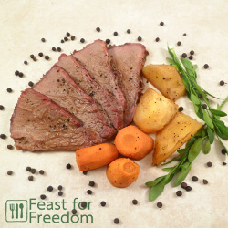 Roast beef with carrots and potatoes on a platter