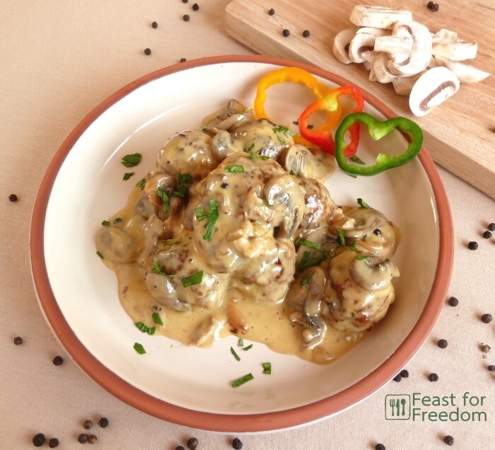 Plate with mushroom meatballs garnished with multi colored sweet peppers