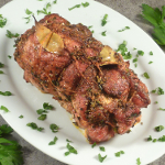Pork Roast garnished with chopped celery on a plate