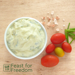 Ranch dressing in a bowl beside cherry tomatoes