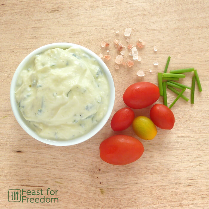 Ranch salad dressing in a bowl with cherry tomatoes