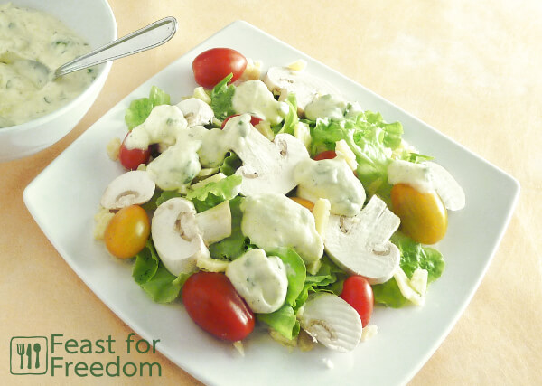 Salad on a plate topped with ranch dressing