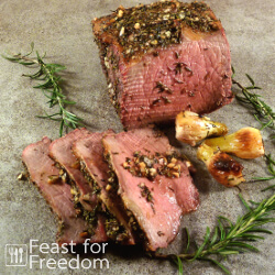 Sliced roast beef with pearl onions and rosemary sprigs