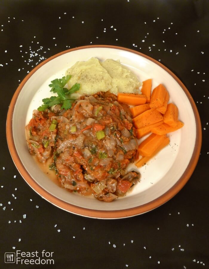 Swiss steak served with mashed potatoes and carrots